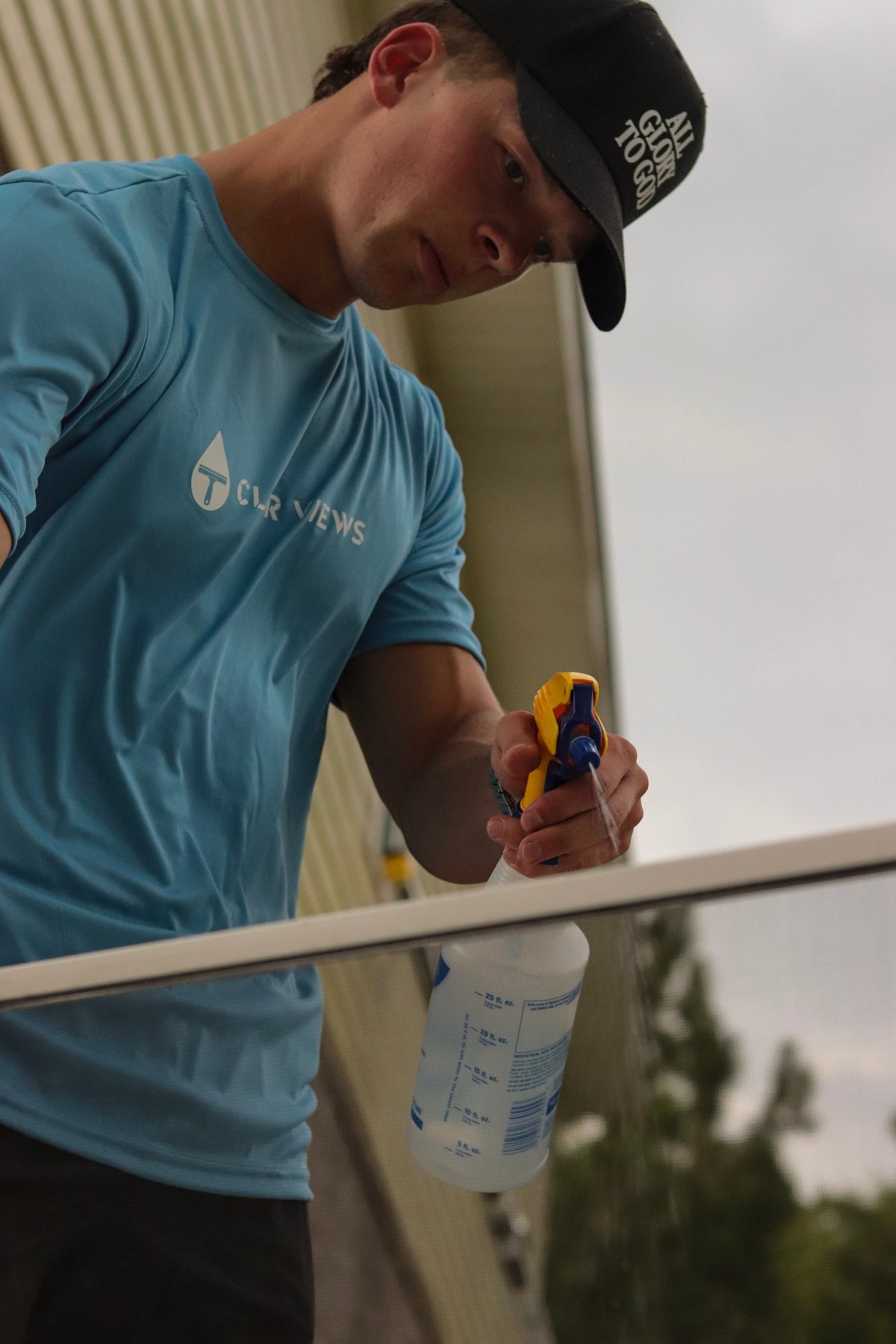 Clear Views technician spraying a window screen